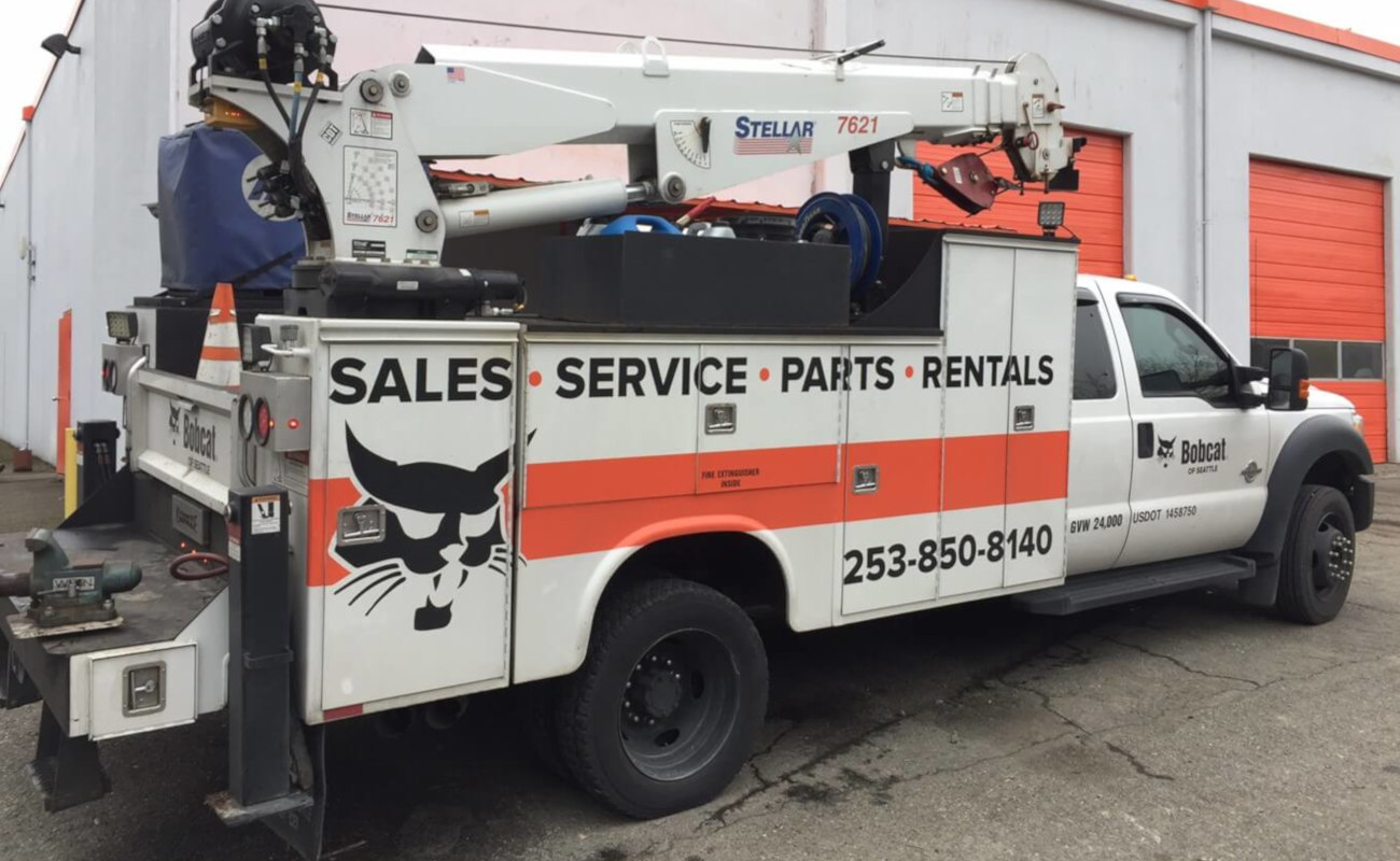 A service truck sitting in front of a building.